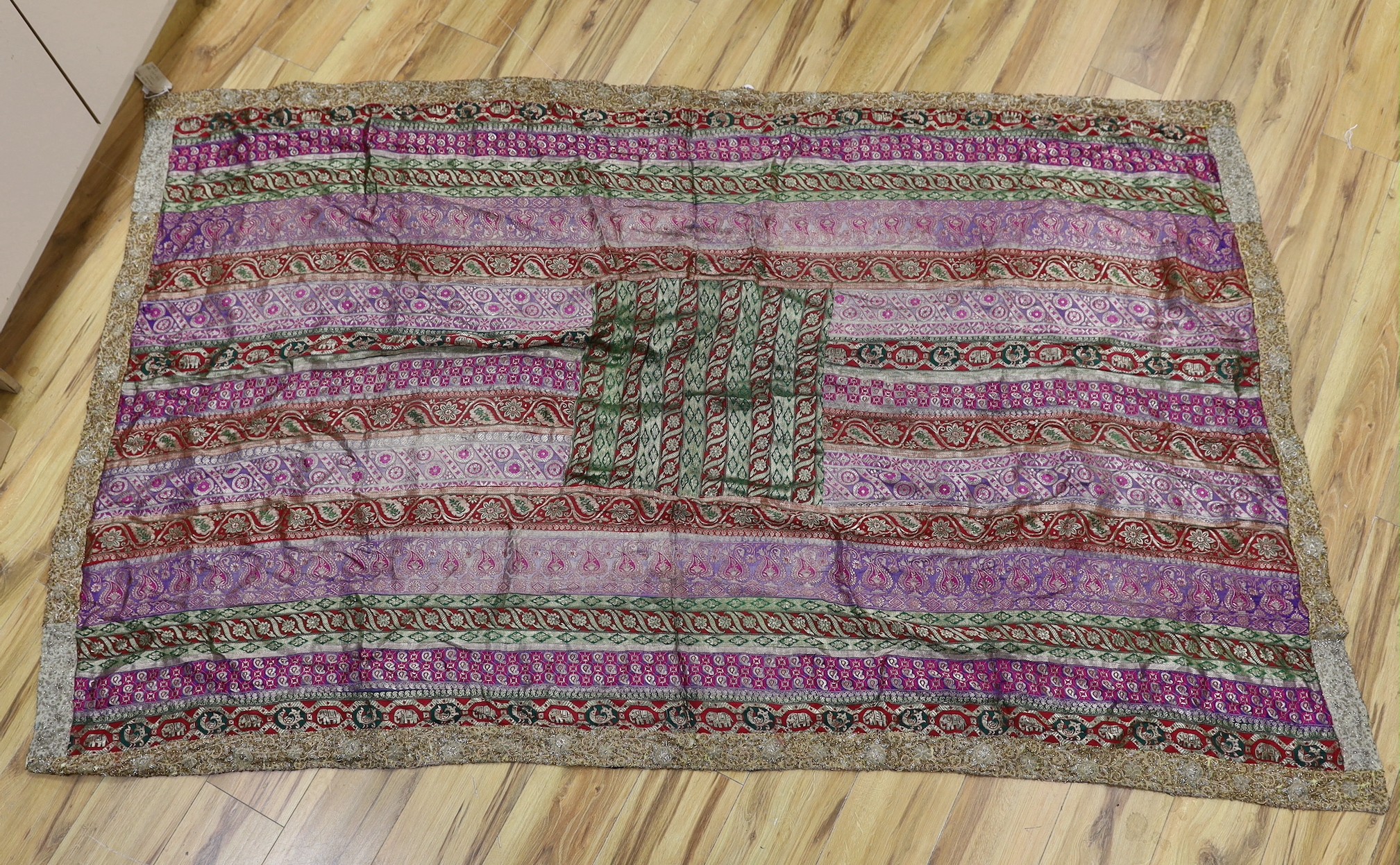 A French 18th century woolwork cushion, 2 chair covers, another panel, a tasselled brocade cushion and an Indian metallic brocaded patchworked cover